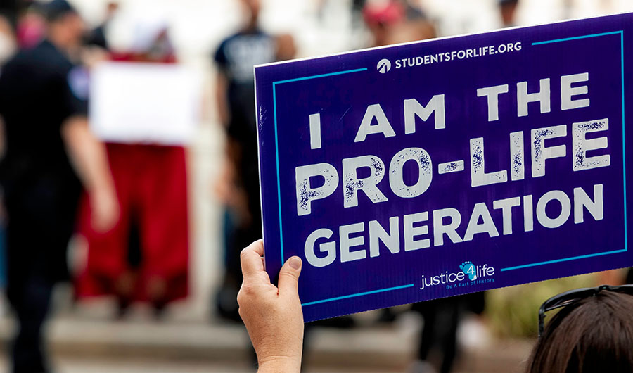 Washington, DC, USA - September 27, 2020: One of the few counter-protesters at the No Confirmation Until Inauguration Rally at the Supreme Court holds a sign that says, "I am the pro-life generation."